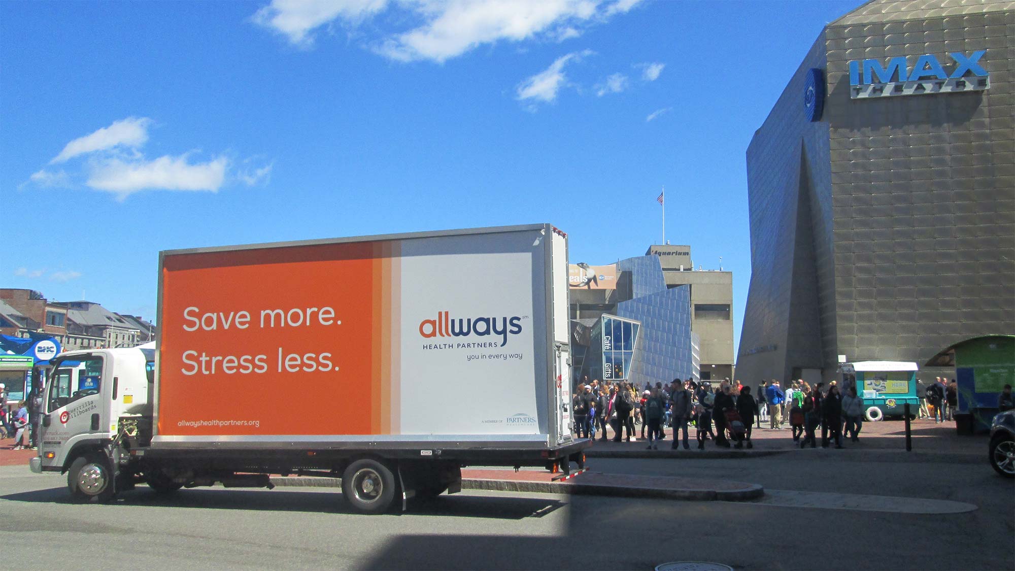 Billboard truck stopped in front of the New England Aquarium in Boston