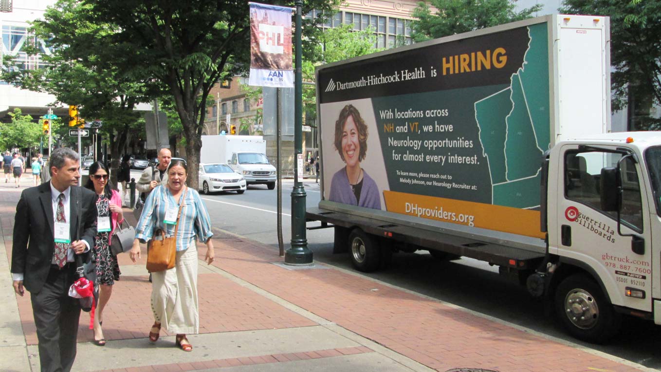 Mobile billboard truck in Philadelphia featuring a now hiring ad.