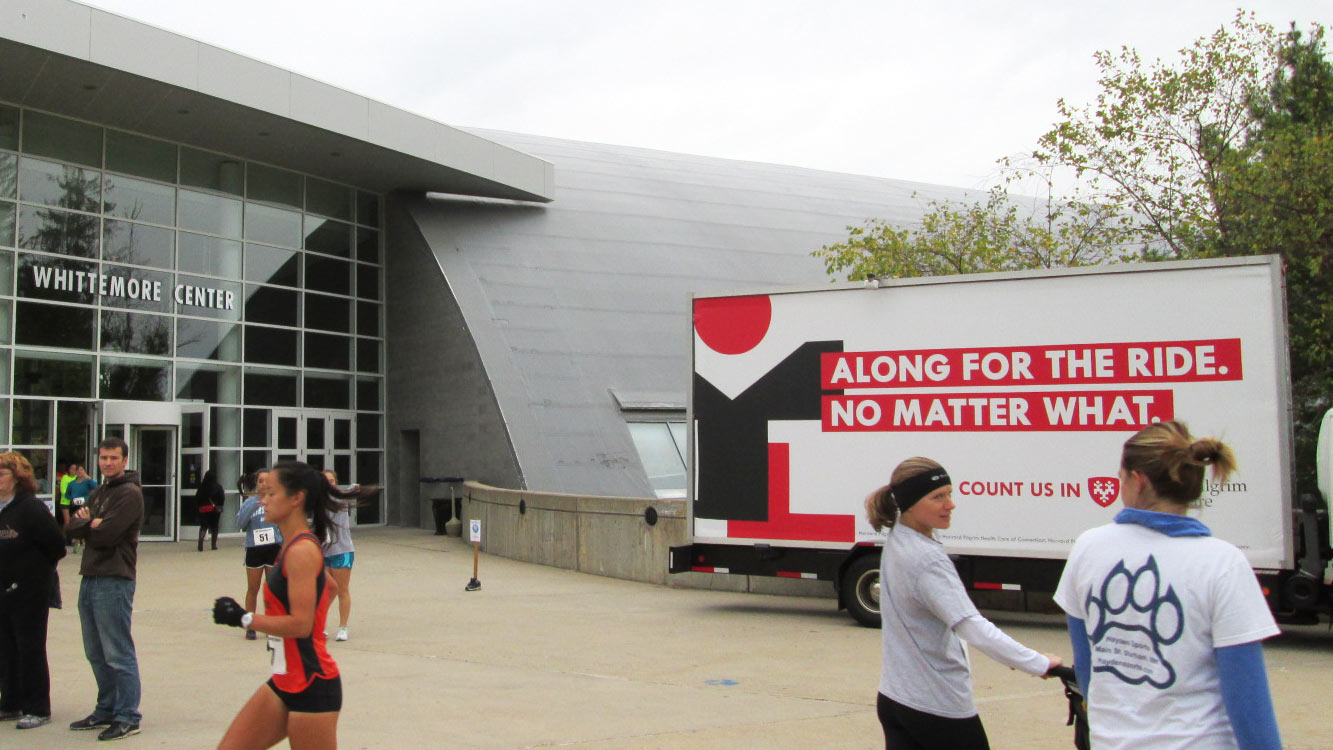 Mobile billboard featuring sponsor ad at UNH event.