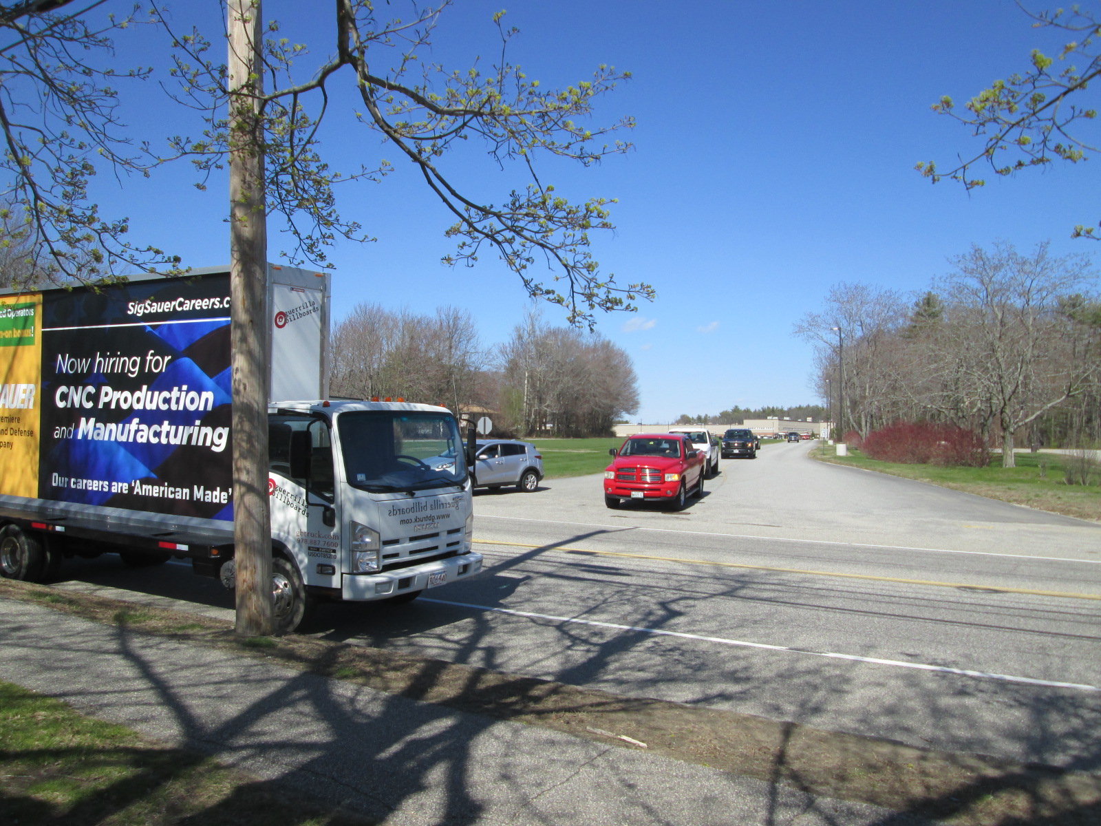 Employee recuiting billboard truck ad with shift change traffic in Southern Maine