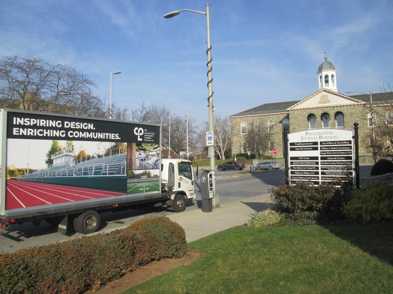Mobile billboard stopped at the Poughkeepsie Journal Building in Poughkeepsie NY