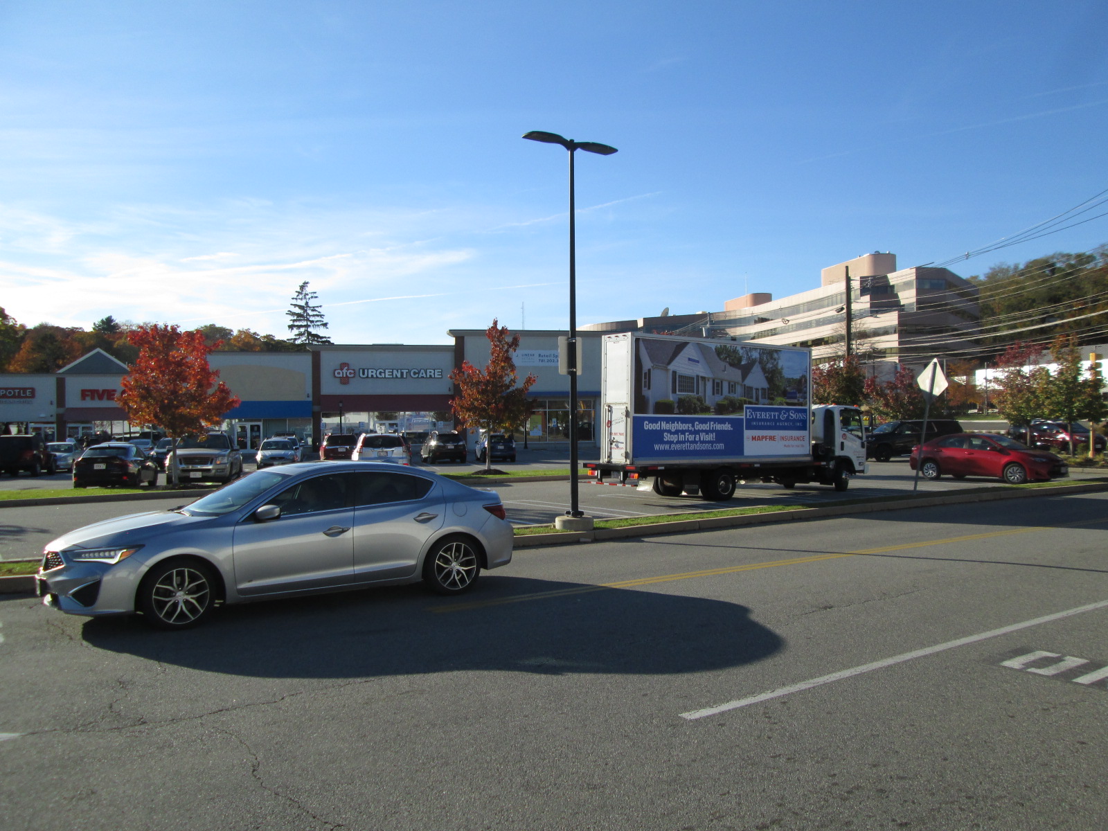 Mobile billboard truck parked at Waltham MA retail plaza.