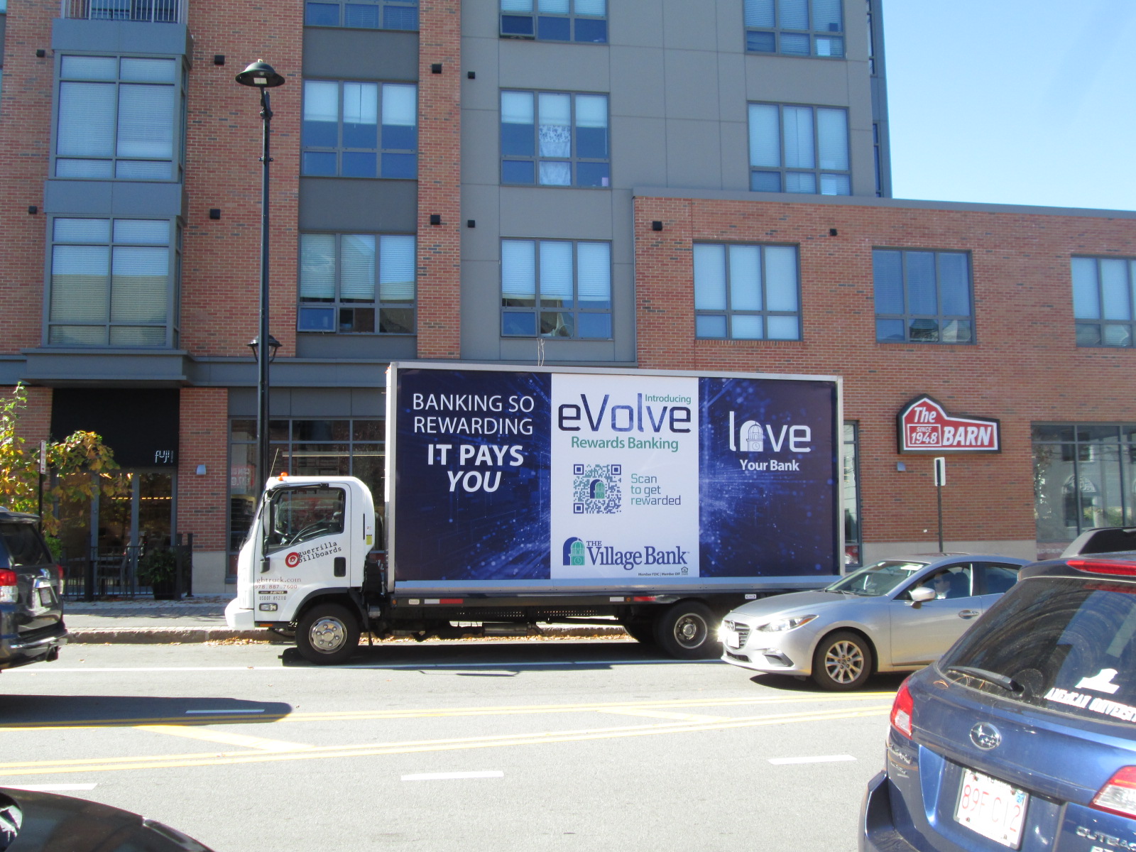 Mobile billboard truck stopped in front of The Barn Family Shoe Store on Walnut Street in Newtonville MA