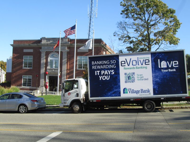 Mobile billboard stopped in front of Newton City Hall in Newton MA