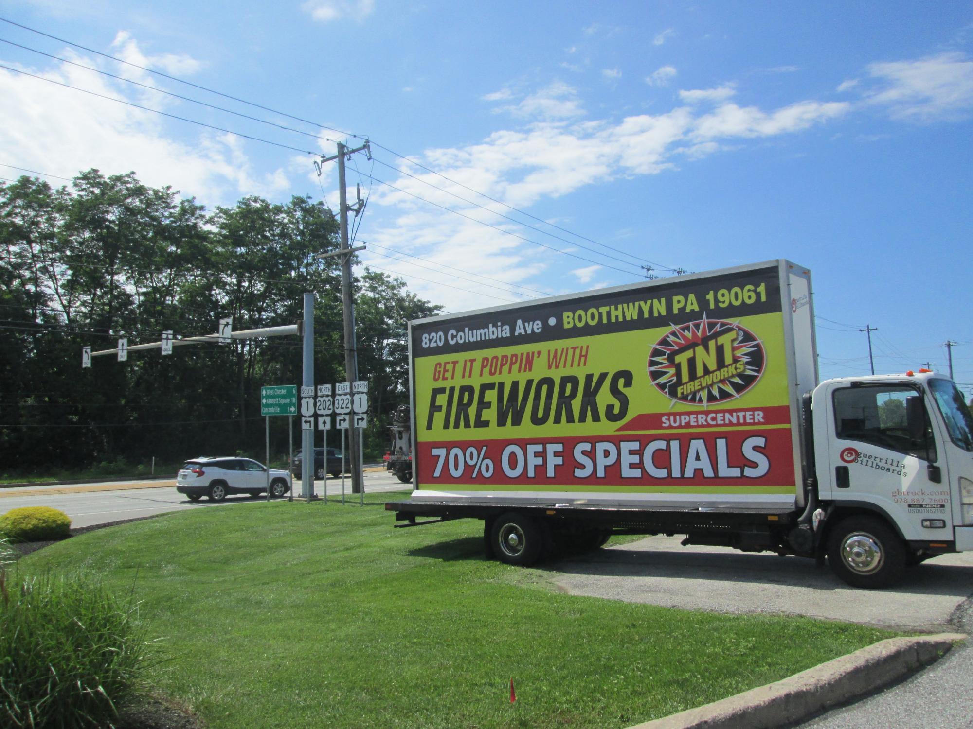 Mobile billboard truck promoting 2023 holiday sale for TNT Fireworks.