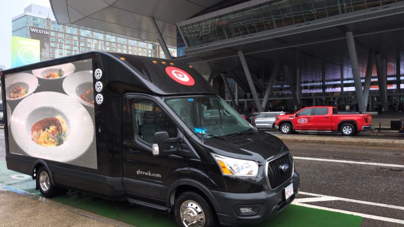Plates of prepared Octopus displayed on a LED billboard truck during a seafood convention in Boston, MA.