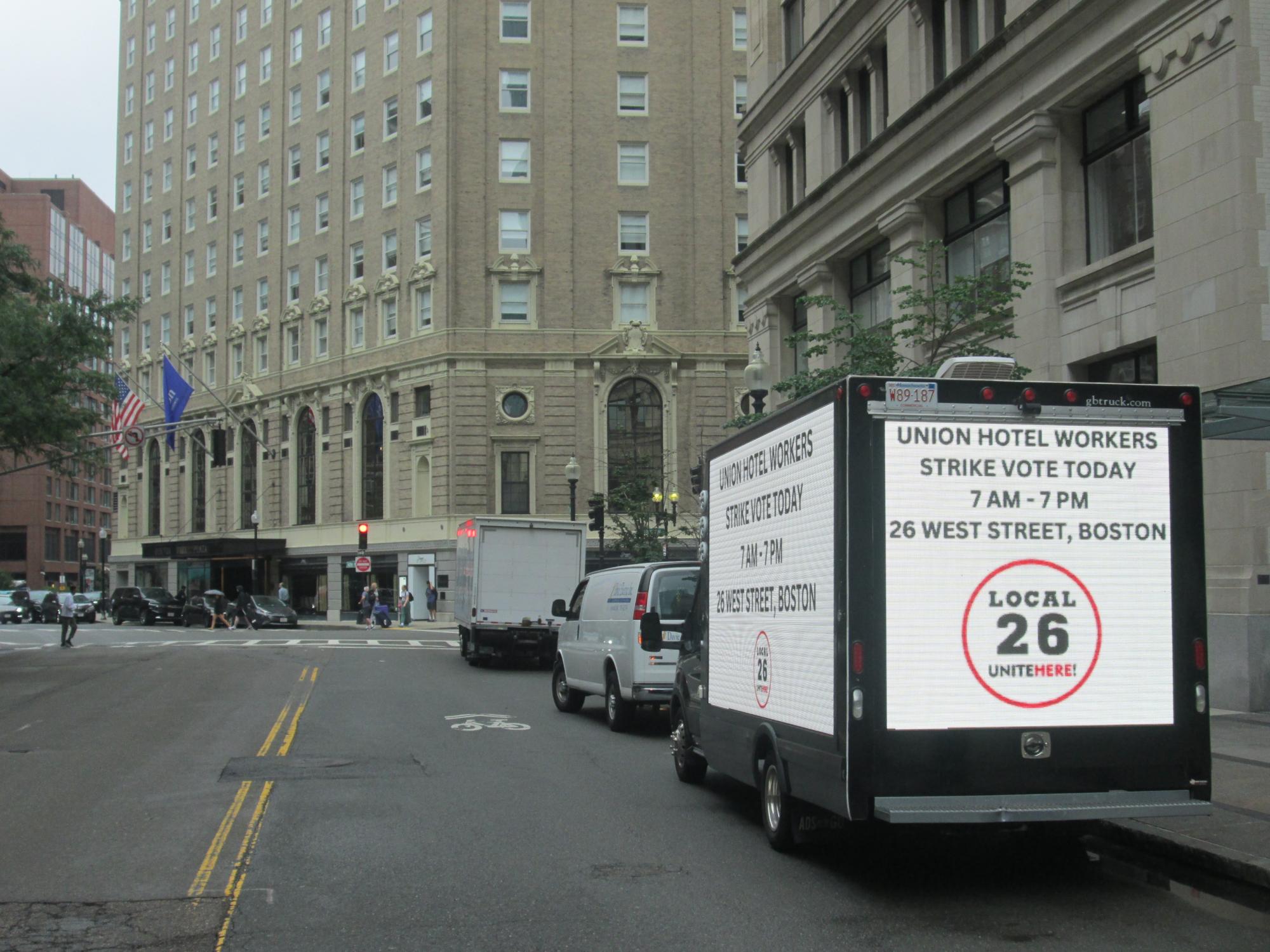 LED billboard truck stopped along St. James Avenue near the Boston Common and the Public Garden.