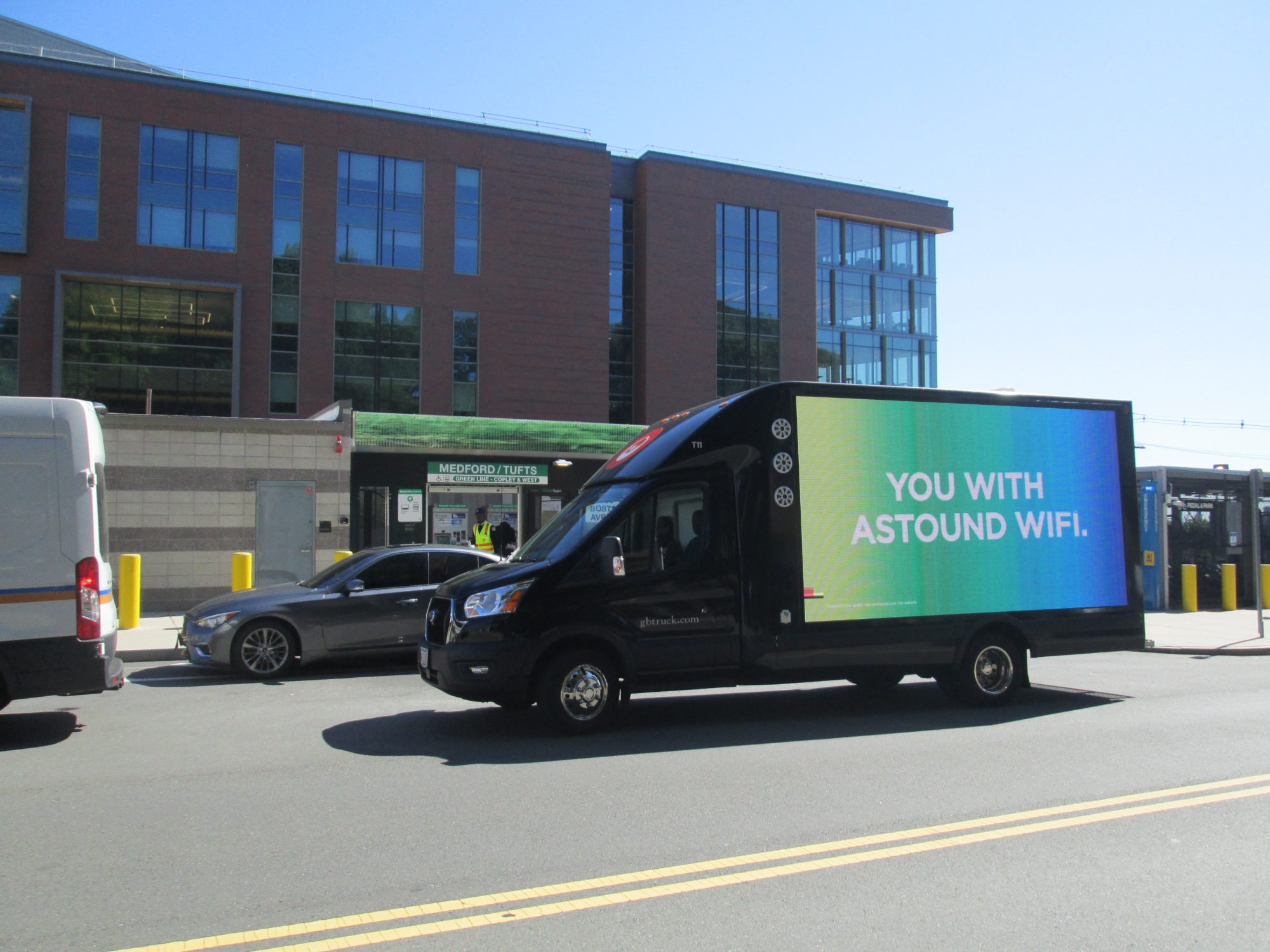 Digital mobile billboard truck stopped at the Medford-Tufts MBTA Greenline Station near Boston MA.