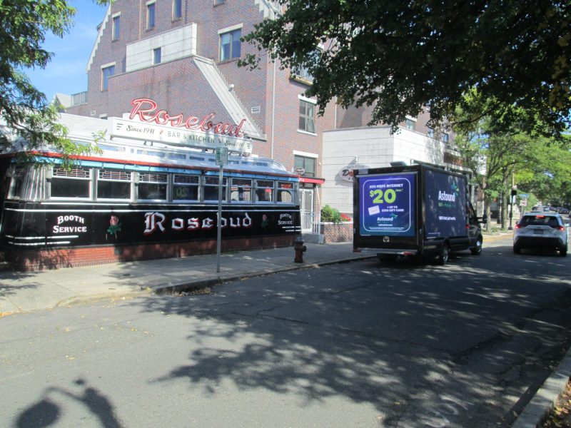 Mobile digital billboard stopped at the Rosebud Diner in Davis Square, Somerville MA, near Boston.