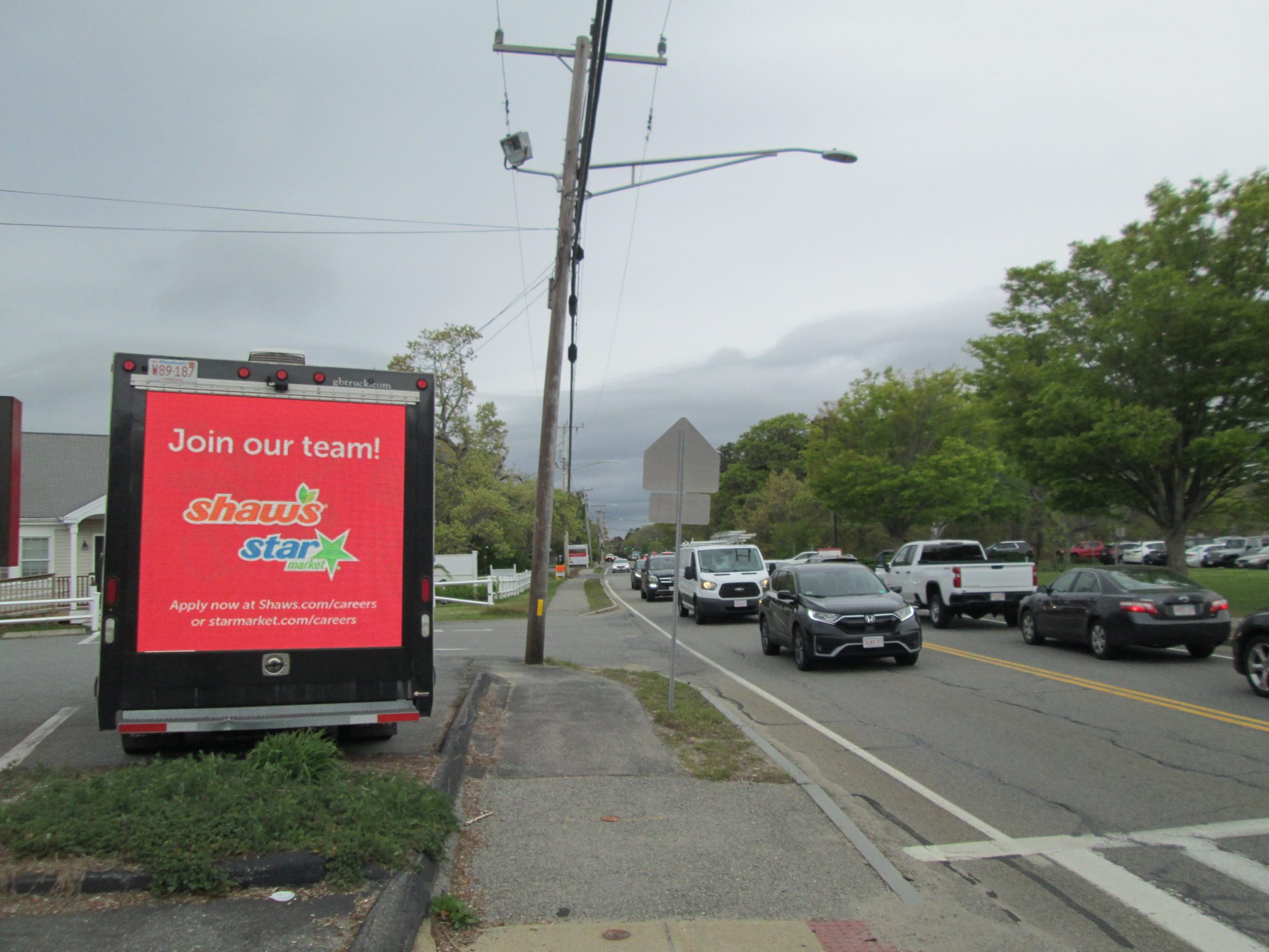 Mobile digital billboard truck stopped along Route 28 in Hyannis MA across from Barnstable High School during the afternoon student dismissal.