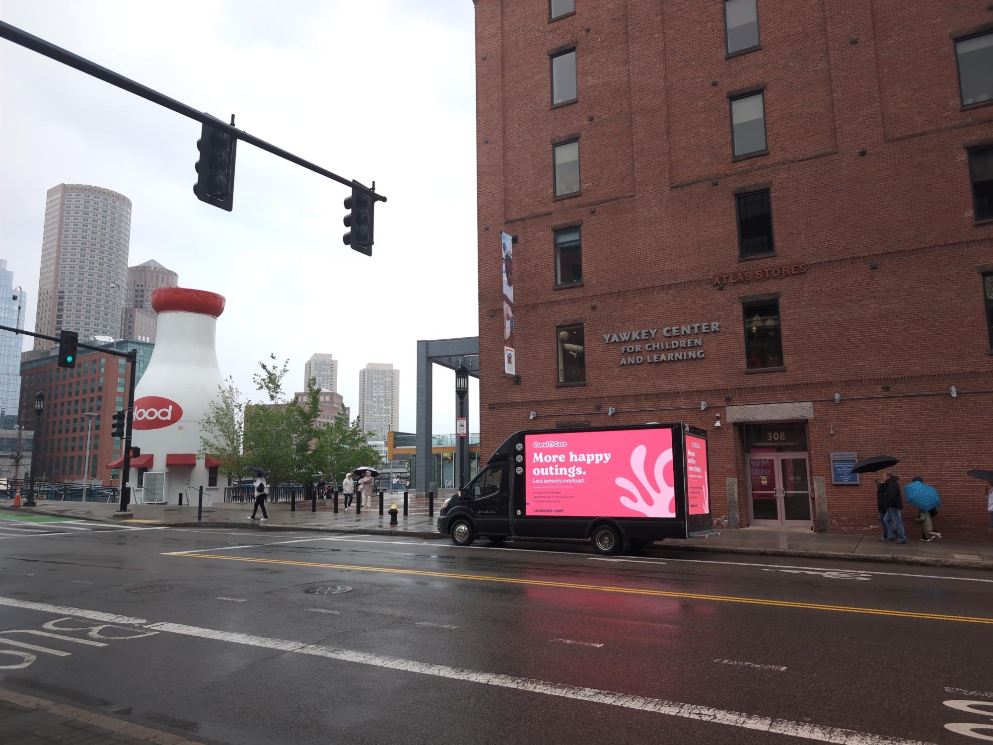 Digital mobile billboard truck with a parent focused ad stopped at the Boston Children's Museum.