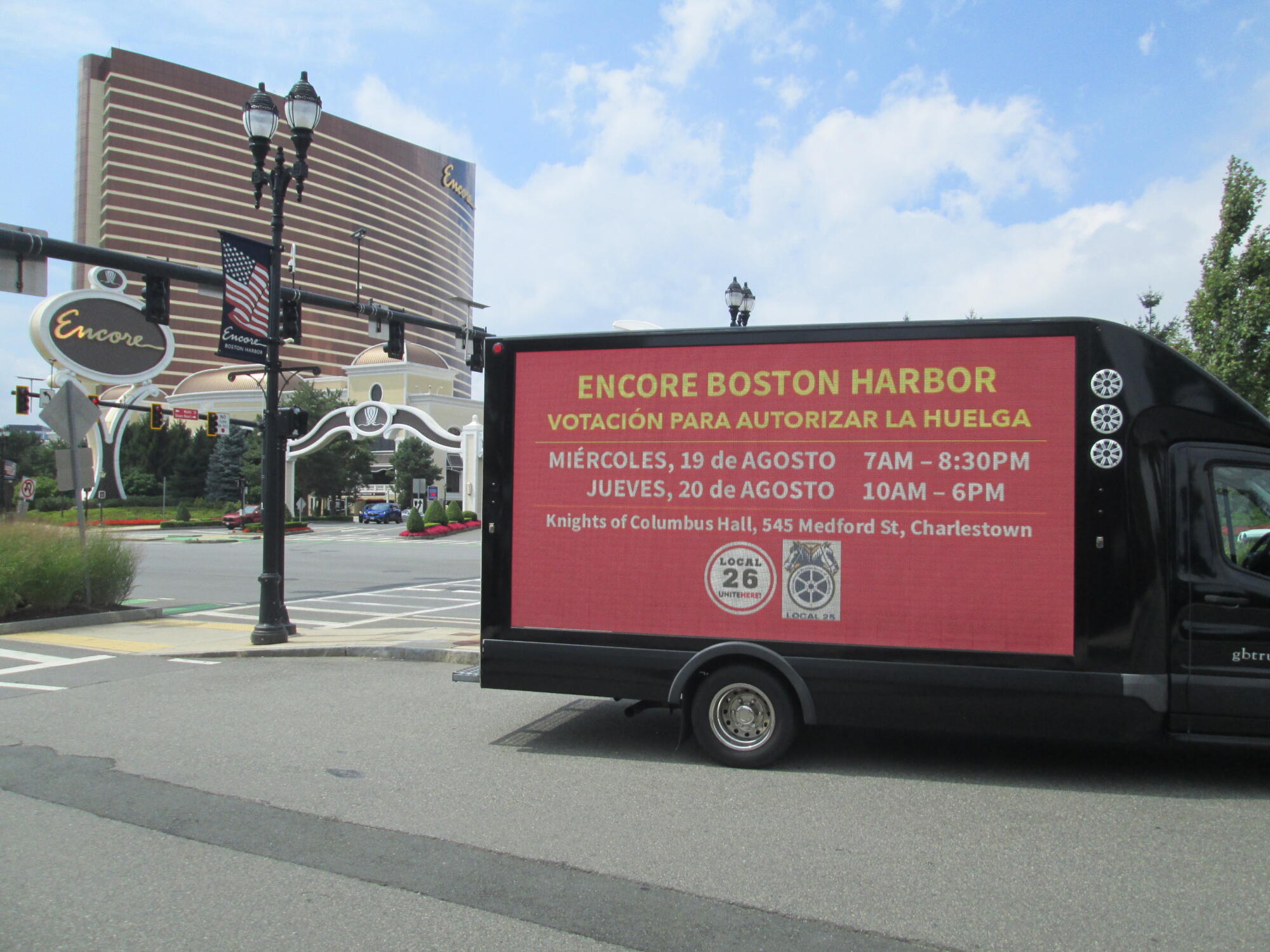 Boston area labor union's LED mobile billboard strike vote awareness message in Spanish.